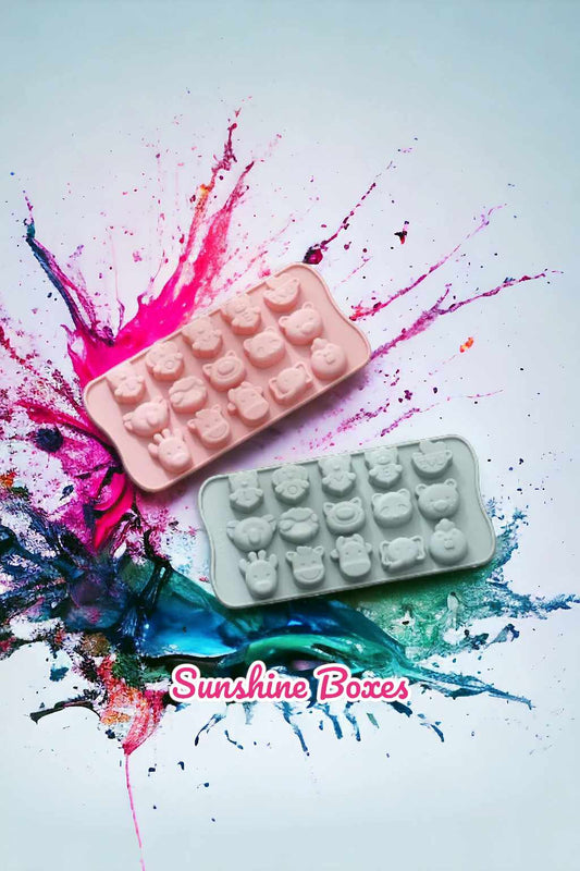 Two silicone animal face molds, one pink and one gray, featuring cute animal faces like bears, monkeys, and lions, displayed on a colorful background.